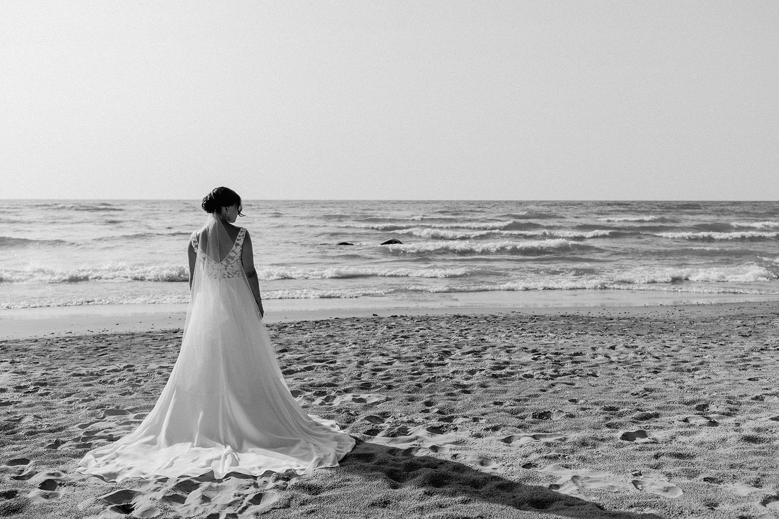 Bride on beach during beach wedding on Lake Huron, in Kincardine Ontario
